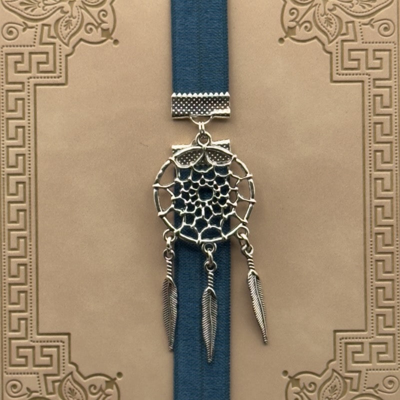 A silver dreamcatcher charm on a elastic Bookband
