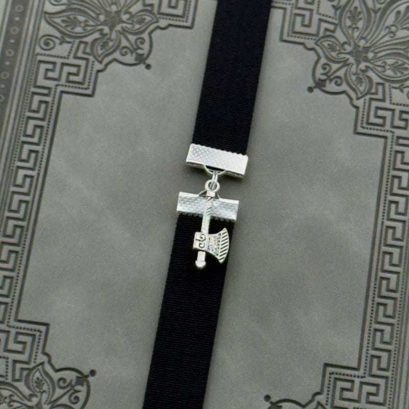 A silver axe charm on an elastic Bookband