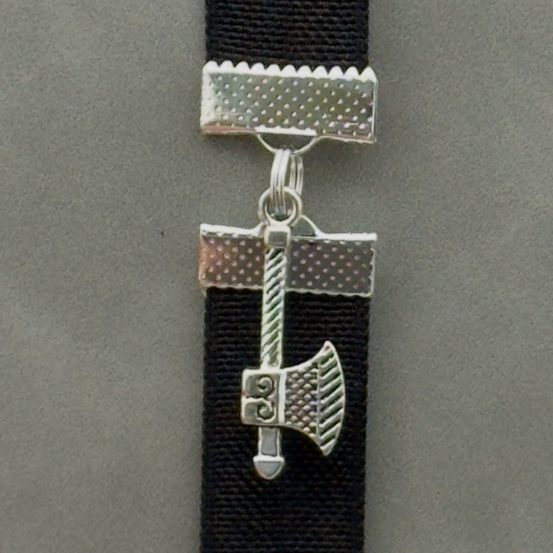 A silver axe charm on an elastic Bookband