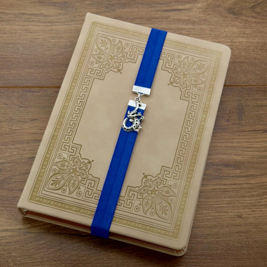A silver cheerful crocodile charm on an elastic Bookband