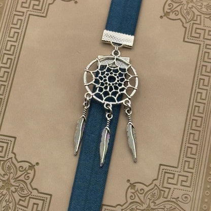 A silver dreamcatcher charm on a elastic Bookband