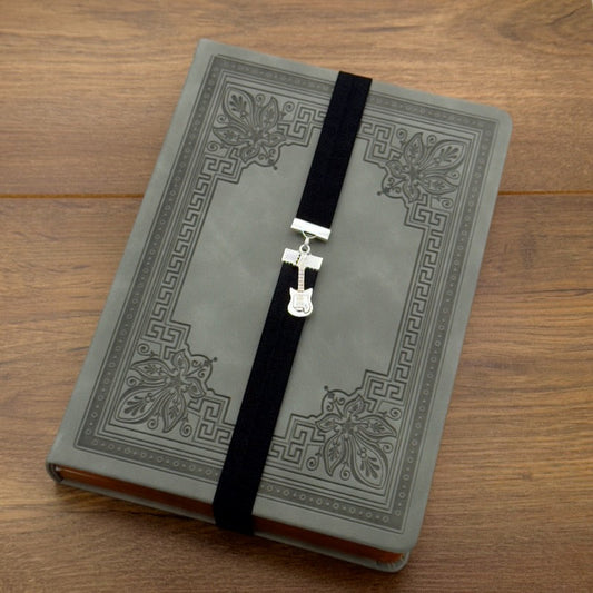 A silver electric guitar charm on an elastic Bookband