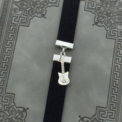 A silver electric guitar charm on an elastic Bookband