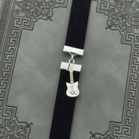 A silver electric guitar charm on an elastic Bookband