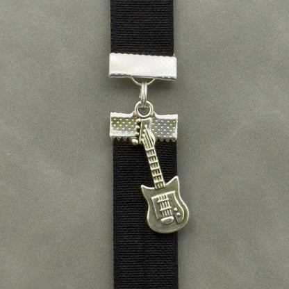 A silver electric guitar charm on an elastic Bookband