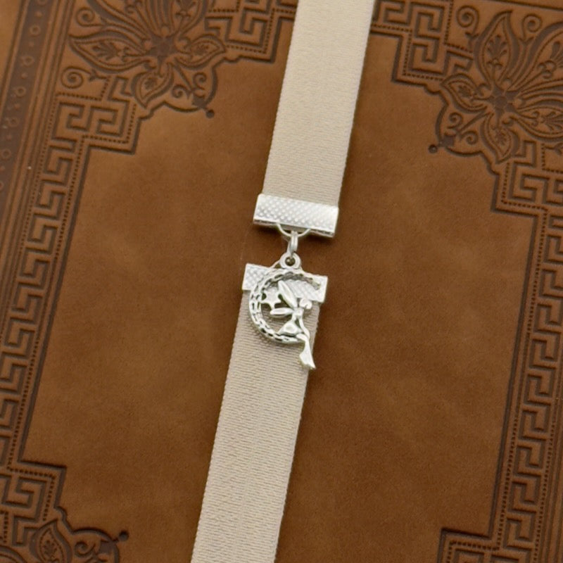 A silver fairy sat in a moon charm on an elastic Bookband