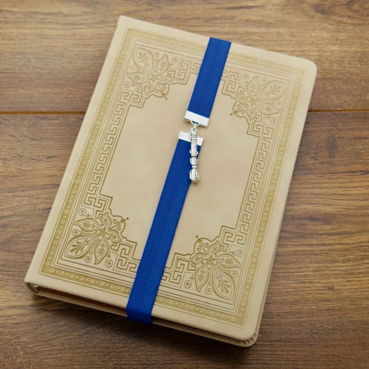 A silver charm, in the shape of Dr. Who's Sonic Screwdriver, on a elastic Bookband